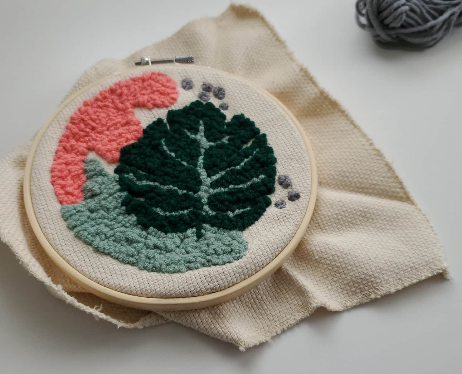 a close up of a piece of cloth with a plant on it